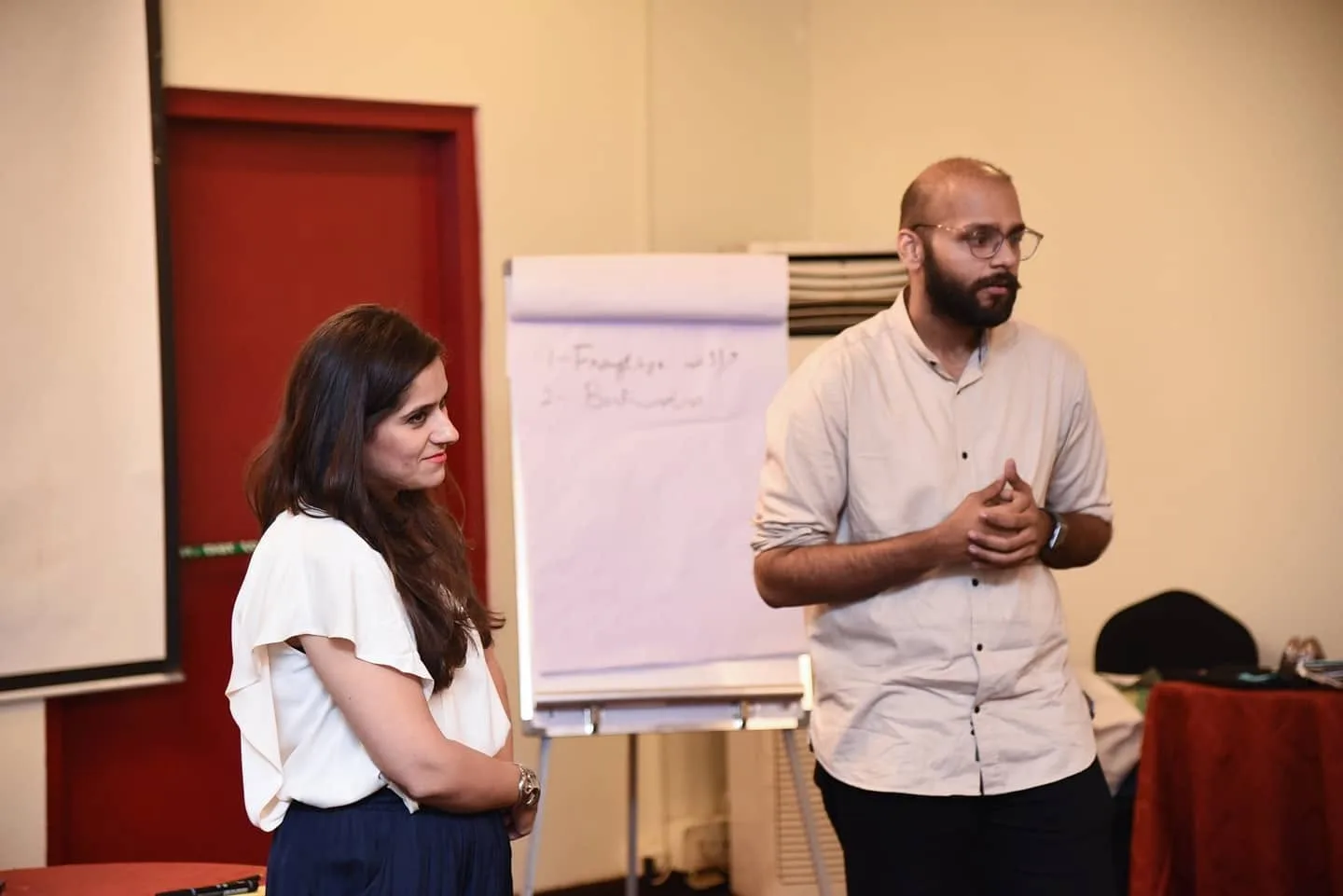 Hassaan Mallick co-facilitating a workshop beside a flip chart